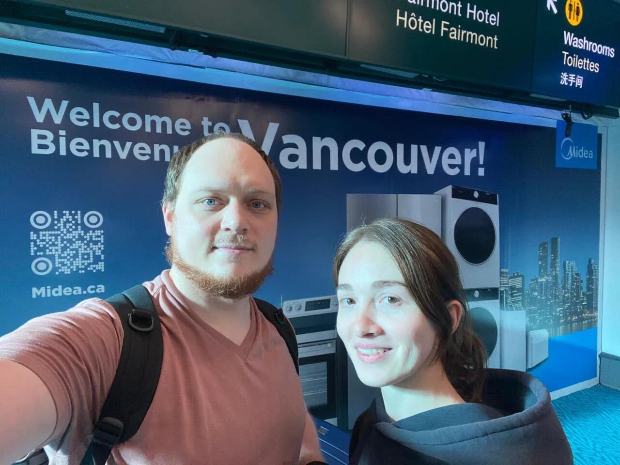 Alex with another person at Vancouver International Airport