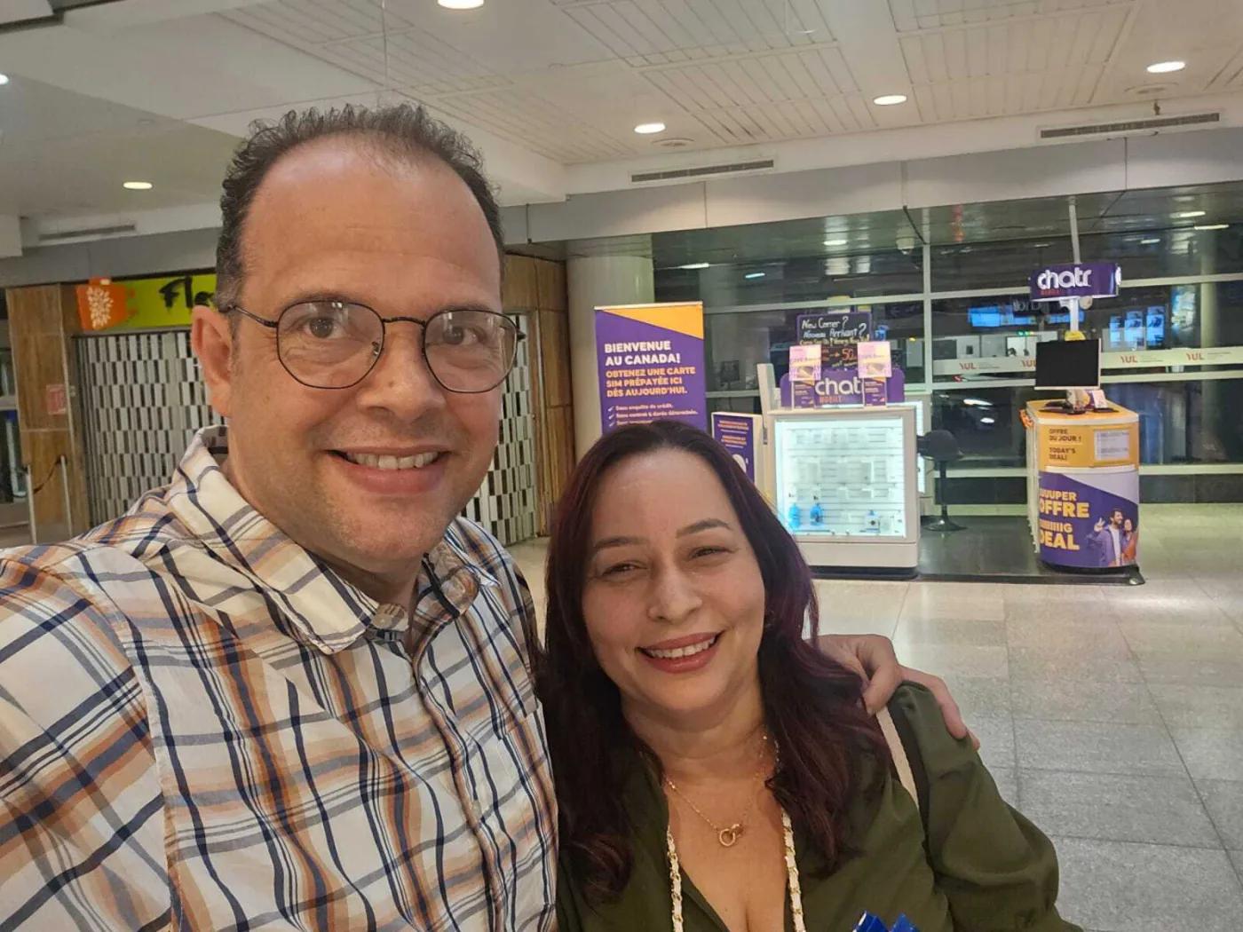 Frank with another person smiling at an airport